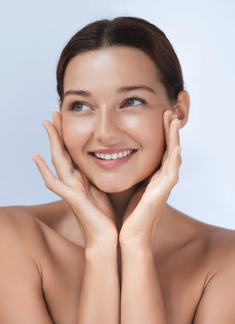 Young smiling woman touching her face