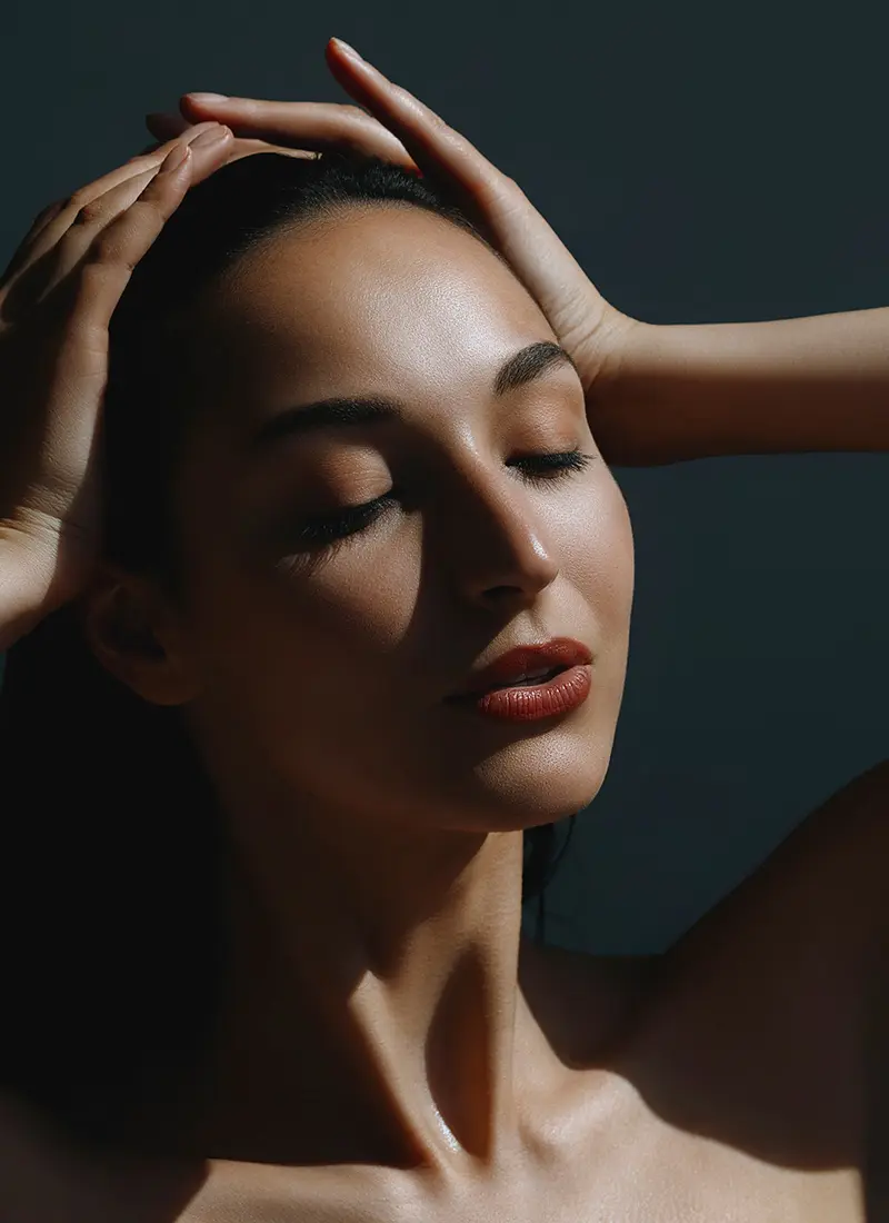 Young woman with her arms on her head